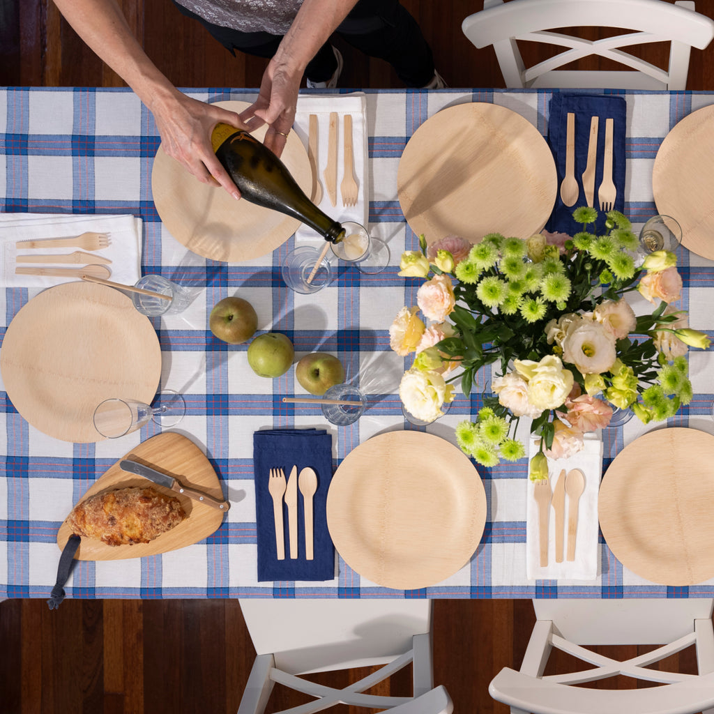 A spring tablescape featured Veneerware Plates with an Arch Board for serving. bambu