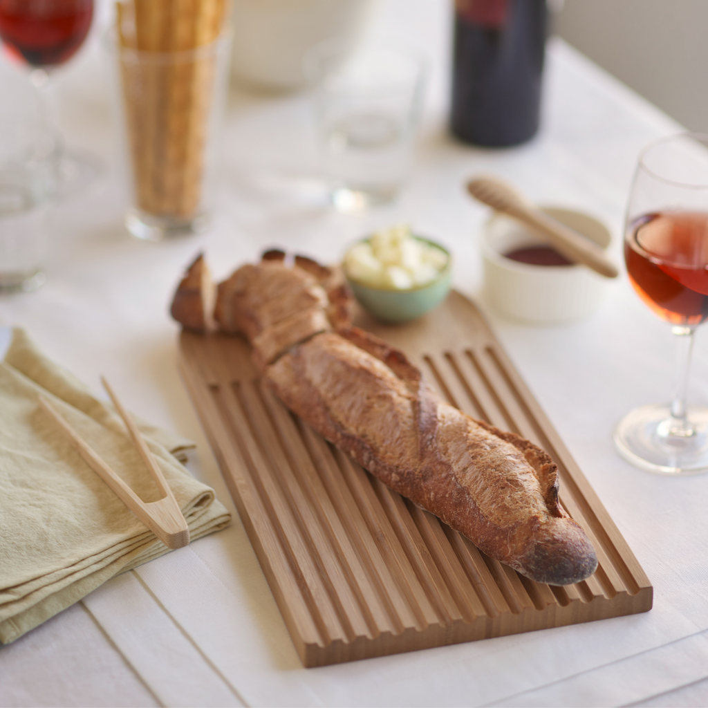 Arch Bread Board will catch crumbs and can double as a serving platter with bread and spread. bambu