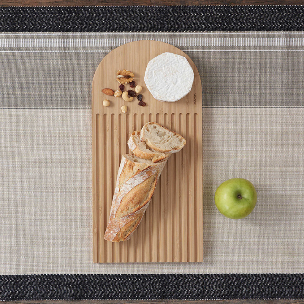 Arch Bread Board will catch crumbs and can double as a serving platter with cheese and nuts. bambu