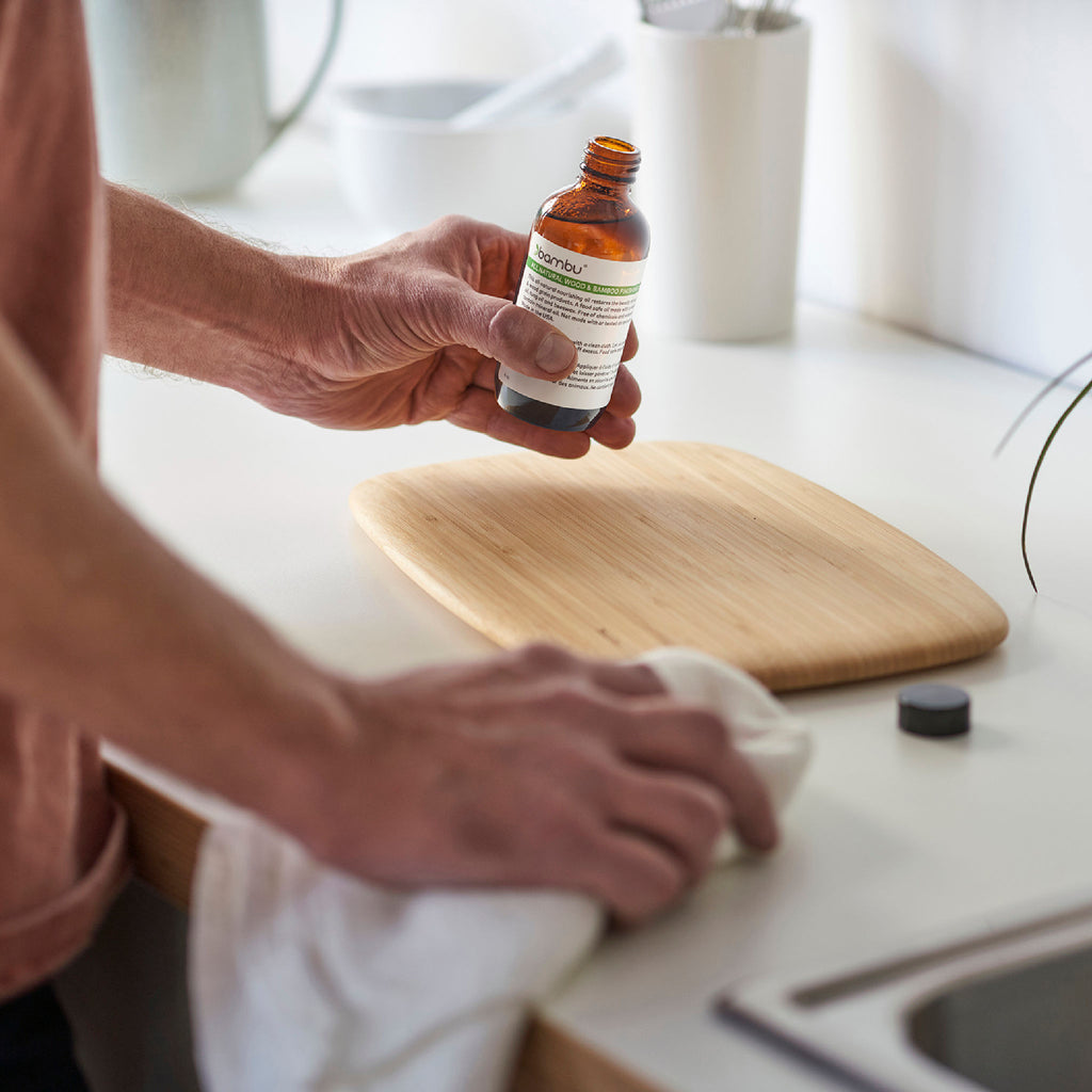 bambu conditioning oil is used on a bamboo cutting board to nourish and revive.