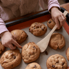 A child uses the Spatula from the Kids in the Kitchen set to lift fresh baked cookies from a tray. bambu