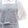 A close up view of the MEEMA Crossback Apron made with Upcycled Denim shows the front pocket.